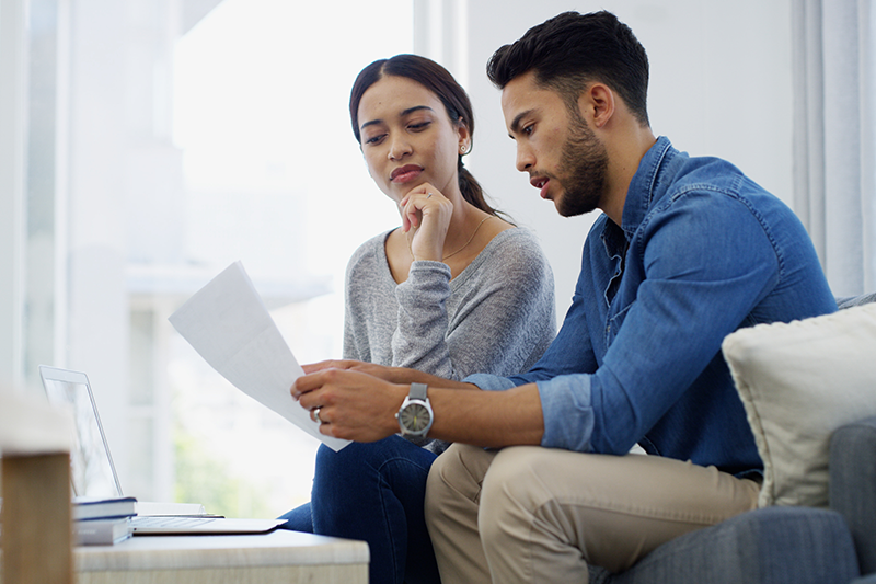 Man and woman look at a document